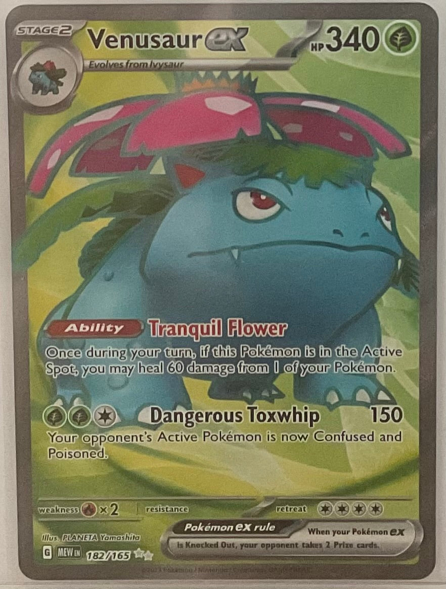 Venusaur EX trading card with detailed artwork and text