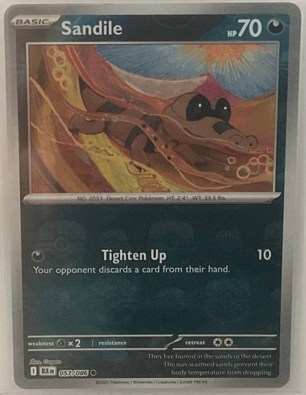 Pokémon trading card featuring Sandile with desert landscape background
